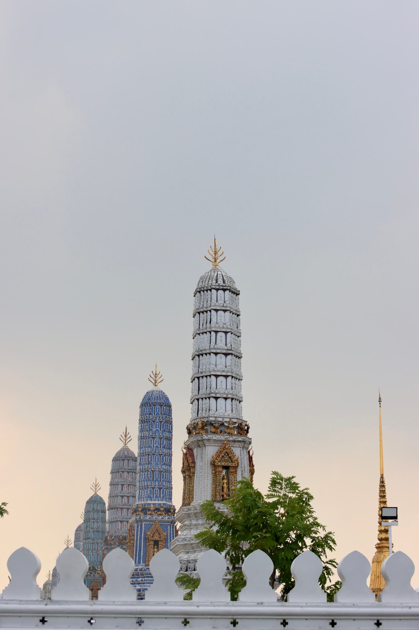 Ornate temple spires rising into the evening sky in Thailand
